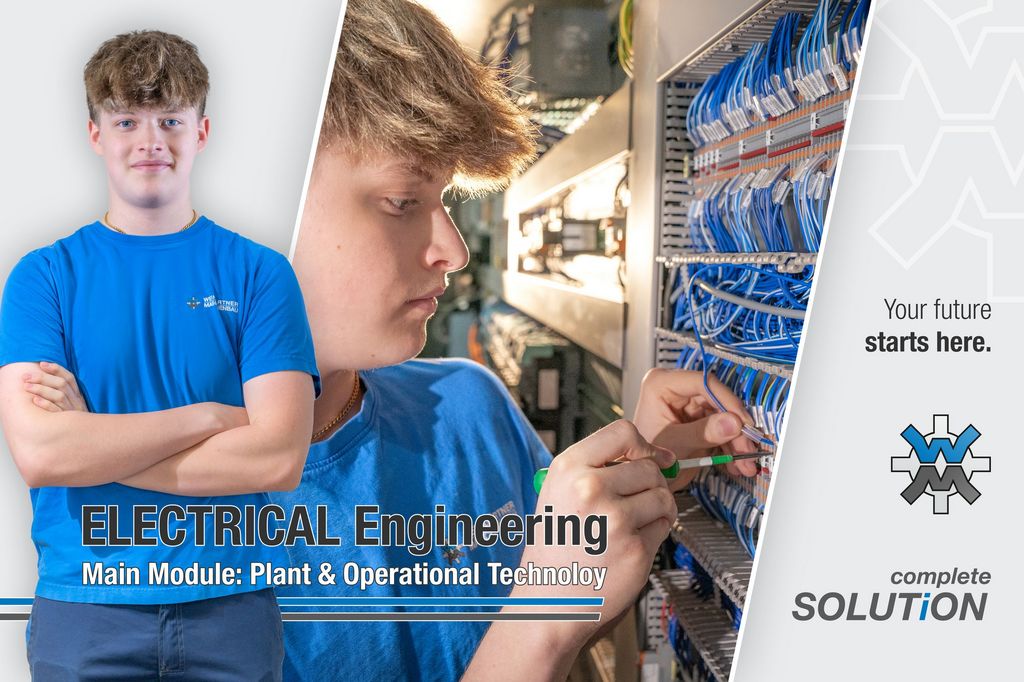 A young man (apprentice) wiring a control panel