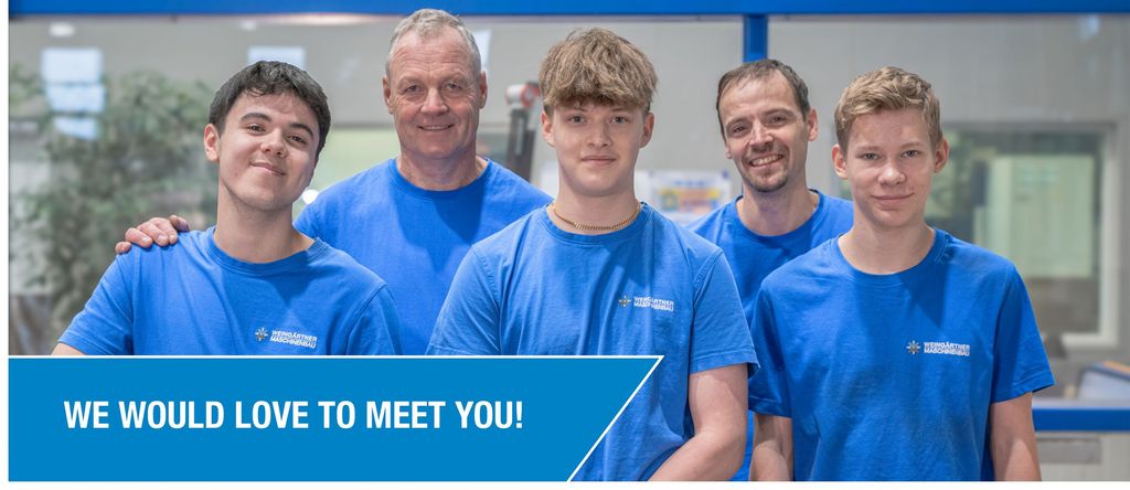 A collective of people standing next to each other smiling at the camera